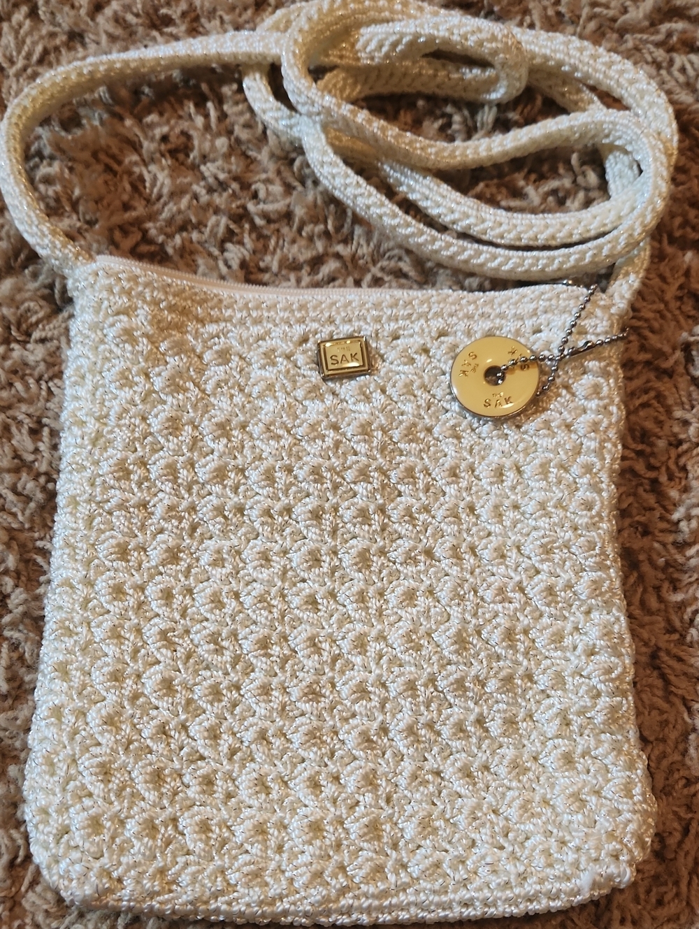 The Sak Cream Crochet Crossbody with Yellow & Silver Charm